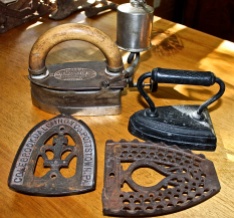 A Collection Of "Sad Irons" And Ironing Trivets
